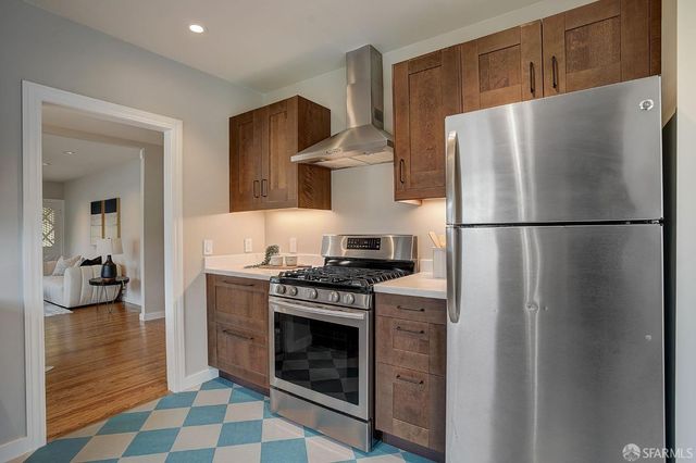 a white refrigerator freezer and a stove sitting inside of a kitchen