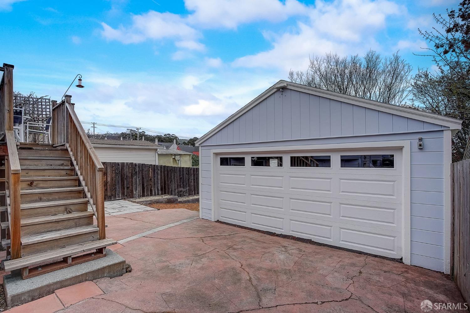 3014 Morcom Avenue Oakland, CA 94619 - Photo 27 of 36 a view of a white house with a small yard and wooden fence