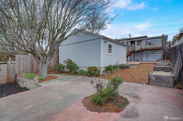 a backyard of a house with plants and trees