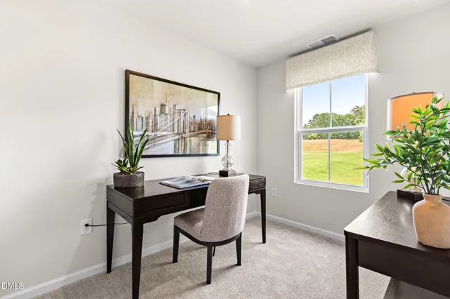 a view of a dining room with furniture and a window