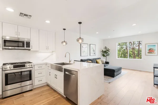 a kitchen with a stove a sink and a microwave