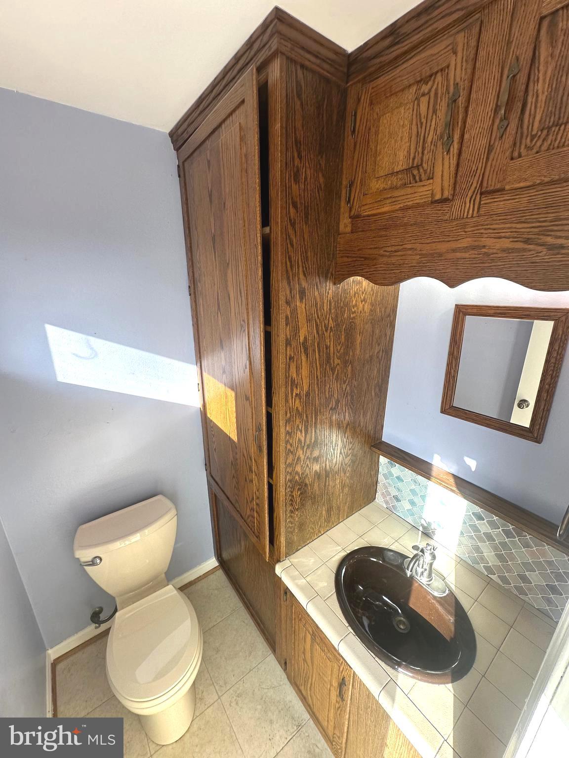 8601 Kenilworth Drive Springfield, VA 22151 - Photo 38 of 47 a bathroom with a sink and a mirror