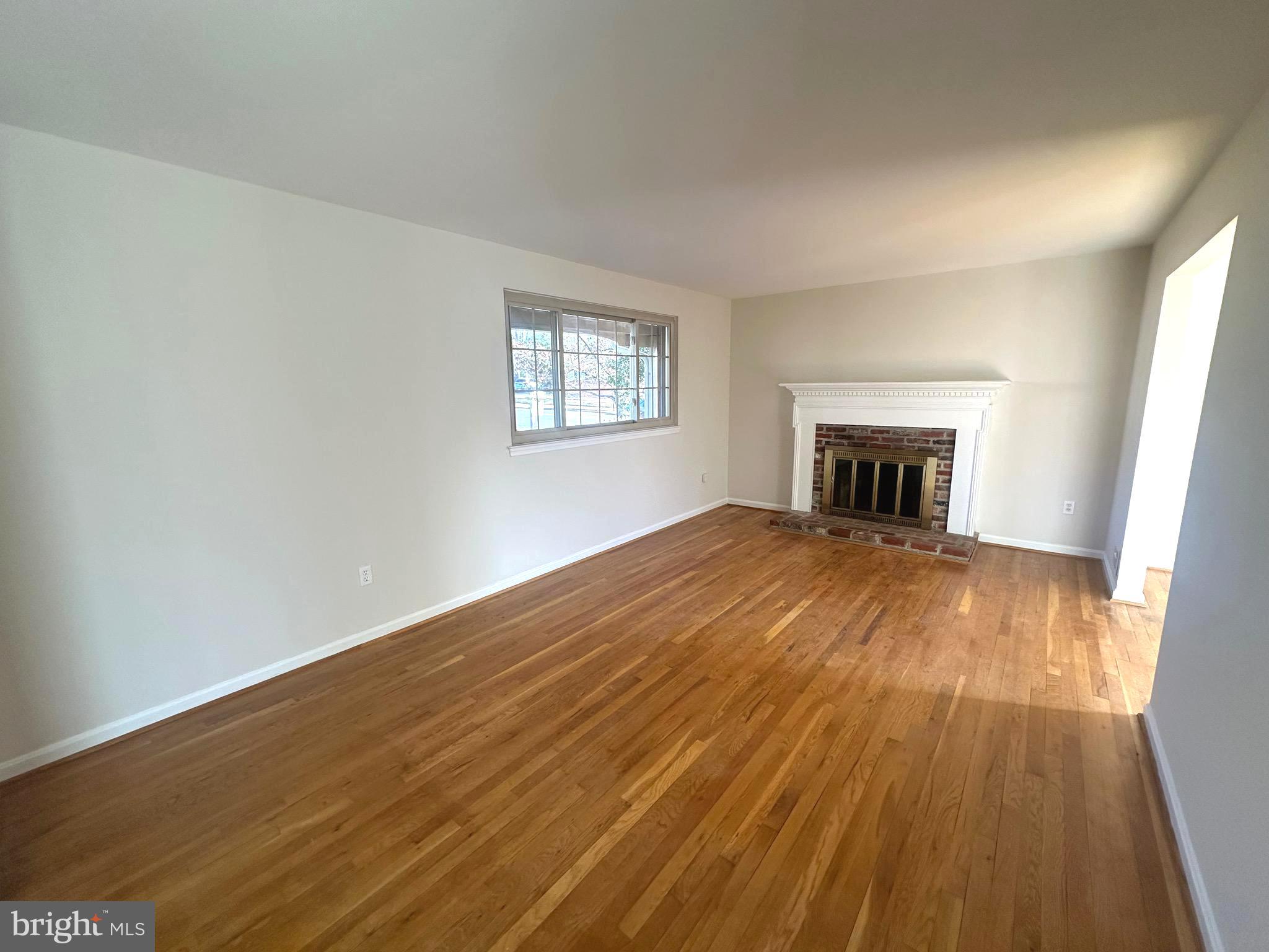 8601 Kenilworth Drive Springfield, VA 22151 - Photo 10 of 47 a view of empty room with wooden floor and fireplace