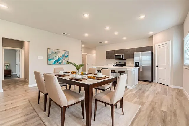 a view of a dining room with furniture and wooden floor