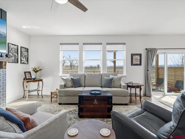 a living room with furniture and a large window