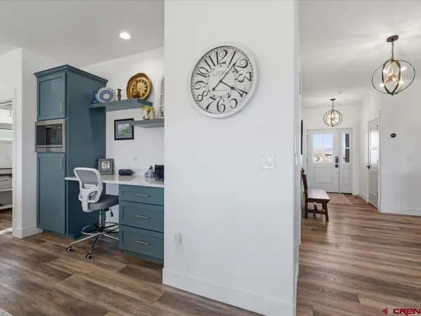 a view of a workspace with furniture and wooden floor