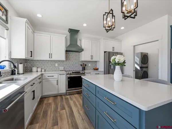 a kitchen with a sink stove and cabinets