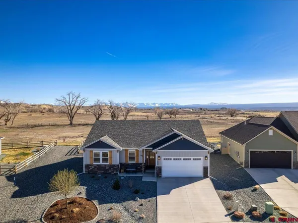 an aerial view of a house with a big yard