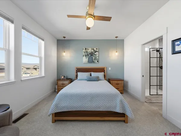 a spacious bedroom with a bed and window
