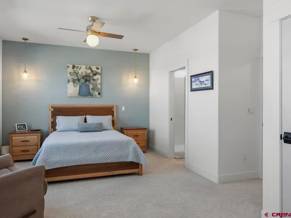 a bedroom with bed and a chandelier