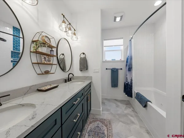 a bathroom with a double vanity sink and a mirror