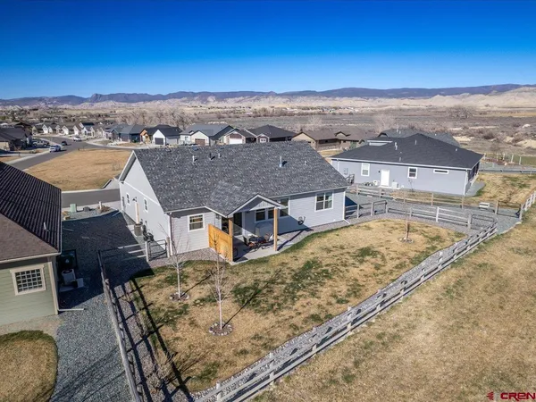 an aerial view of residential houses with outdoor space