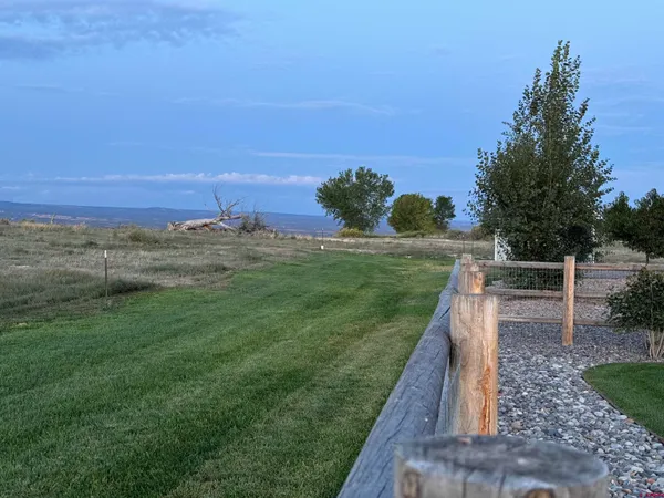 a view of a backyard with ocean view