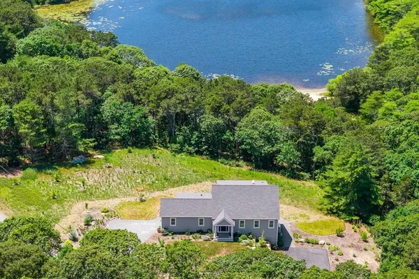 an aerial view of a house with swimming pool and garden