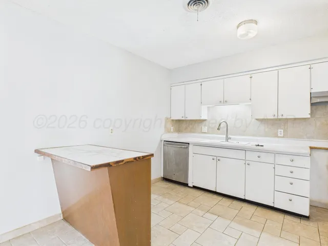 a view interior of kitchen and empty room