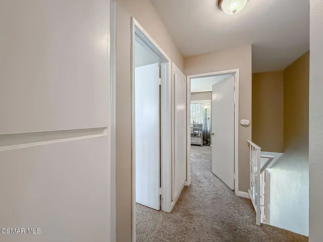 a view of a hallway with wooden floor and closet