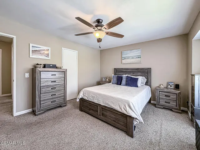 a bedroom with a bed and ceiling fan