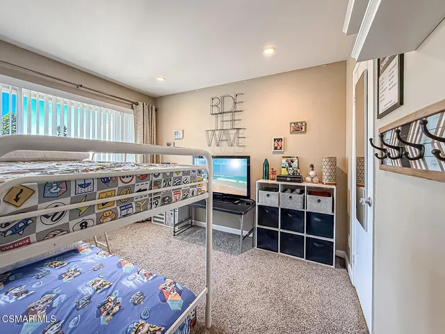 a view of a bedroom with furniture and window