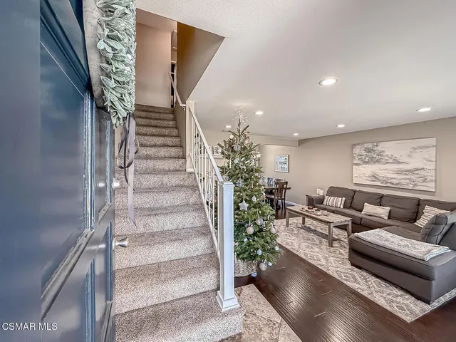 a living room with furniture and stairs