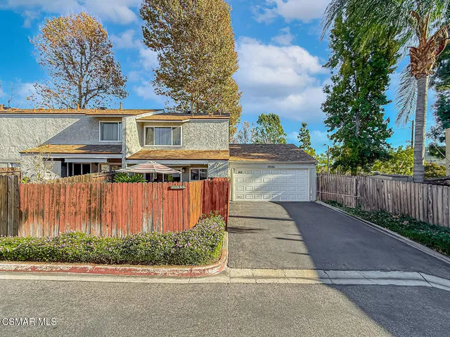 a view of a backyard with sitting area