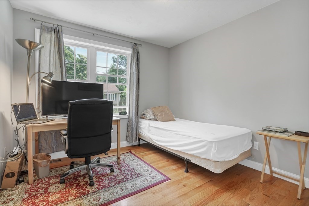 18 Castleton Avenue Randolph, MA 02368 - Photo 14 of 25 a bedroom with a bed and wooden floor