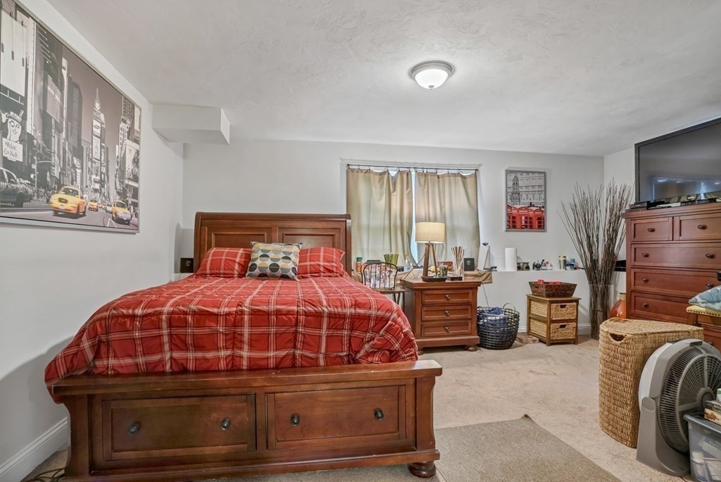 18 Castleton Avenue Randolph, MA 02368 - Photo 17 of 25 a bedroom with a bed and a tv