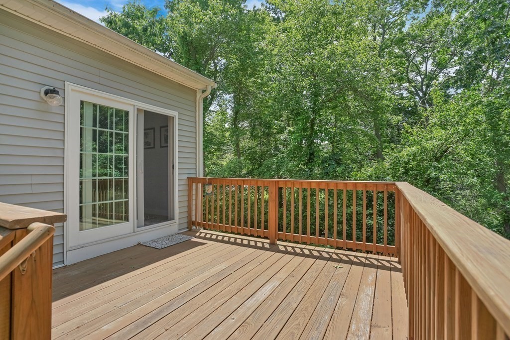 18 Castleton Avenue Randolph, MA 02368 - Photo 21 of 25 a balcony with wooden floor and wooden fence