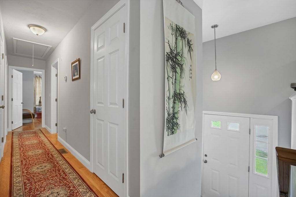 18 Castleton Avenue Randolph, MA 02368 - Photo 9 of 25 a view of a hallway with wooden floor and closet area