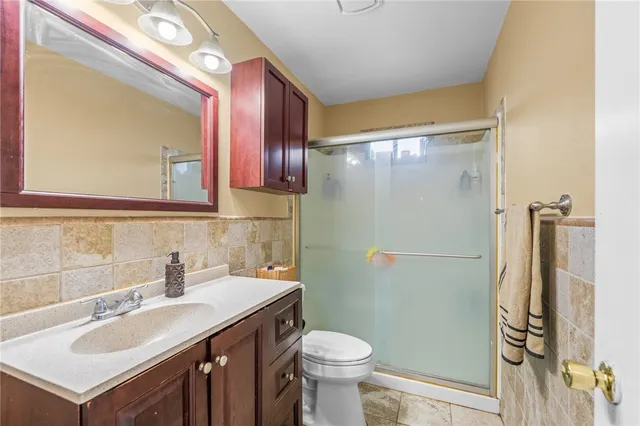 a bathroom with a sink toilet and shower