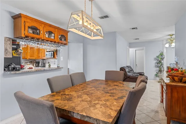 a dining room with furniture and a chandelier
