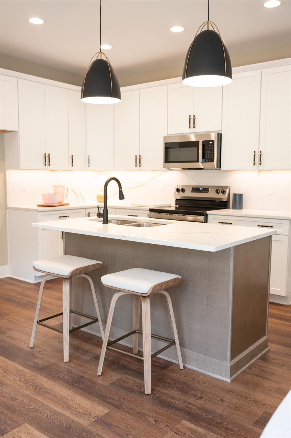57 Luke Court Rustburg, VA 24588 - Photo 11 of 41 a kitchen with stainless steel appliances a dining table a sink a stove and cabinets