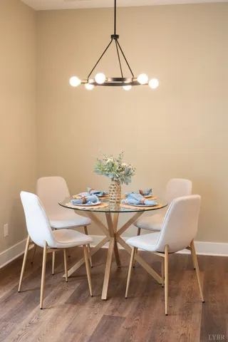 a view of a dining room that has a table and chairs in it