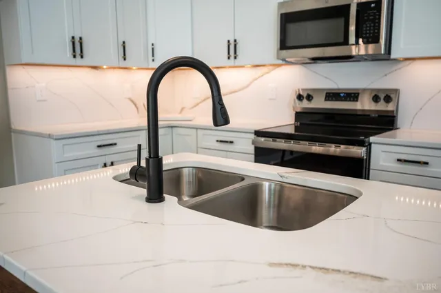 a view of a kitchen with a sink and a stove