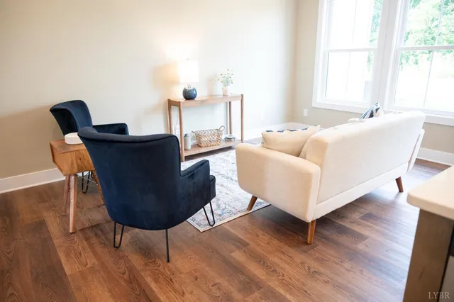 a living room with furniture and a wooden floor