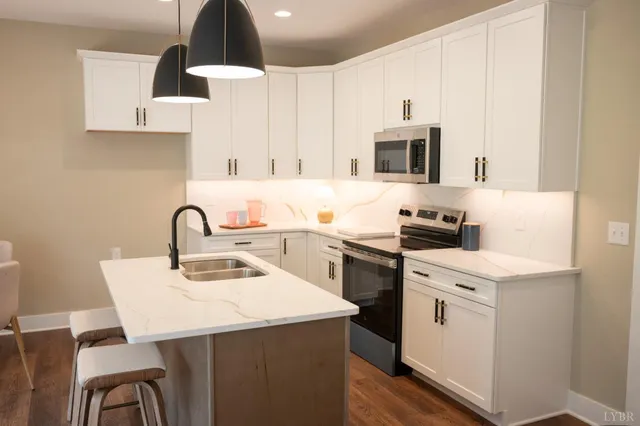 a kitchen with a sink a stove and cabinets
