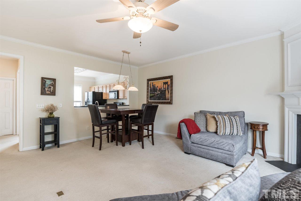 5522 Shady Crest Drive Raleigh, NC 27613 - Photo 13 of 25 a living room with furniture a dining table and a chandelier