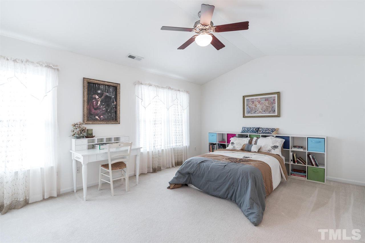 5522 Shady Crest Drive Raleigh, NC 27613 - Photo 16 of 25 a bedroom with a bed chandelier and a window