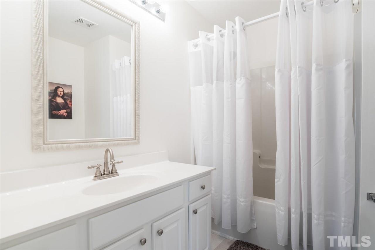 5522 Shady Crest Drive Raleigh, NC 27613 - Photo 17 of 25 a bathroom with a sink and a mirror