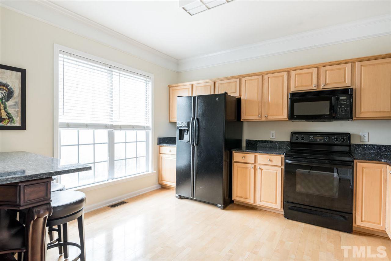 5522 Shady Crest Drive Raleigh, NC 27613 - Photo 8 of 25 a kitchen with stainless steel appliances granite countertop a stove a refrigerator and a microwave