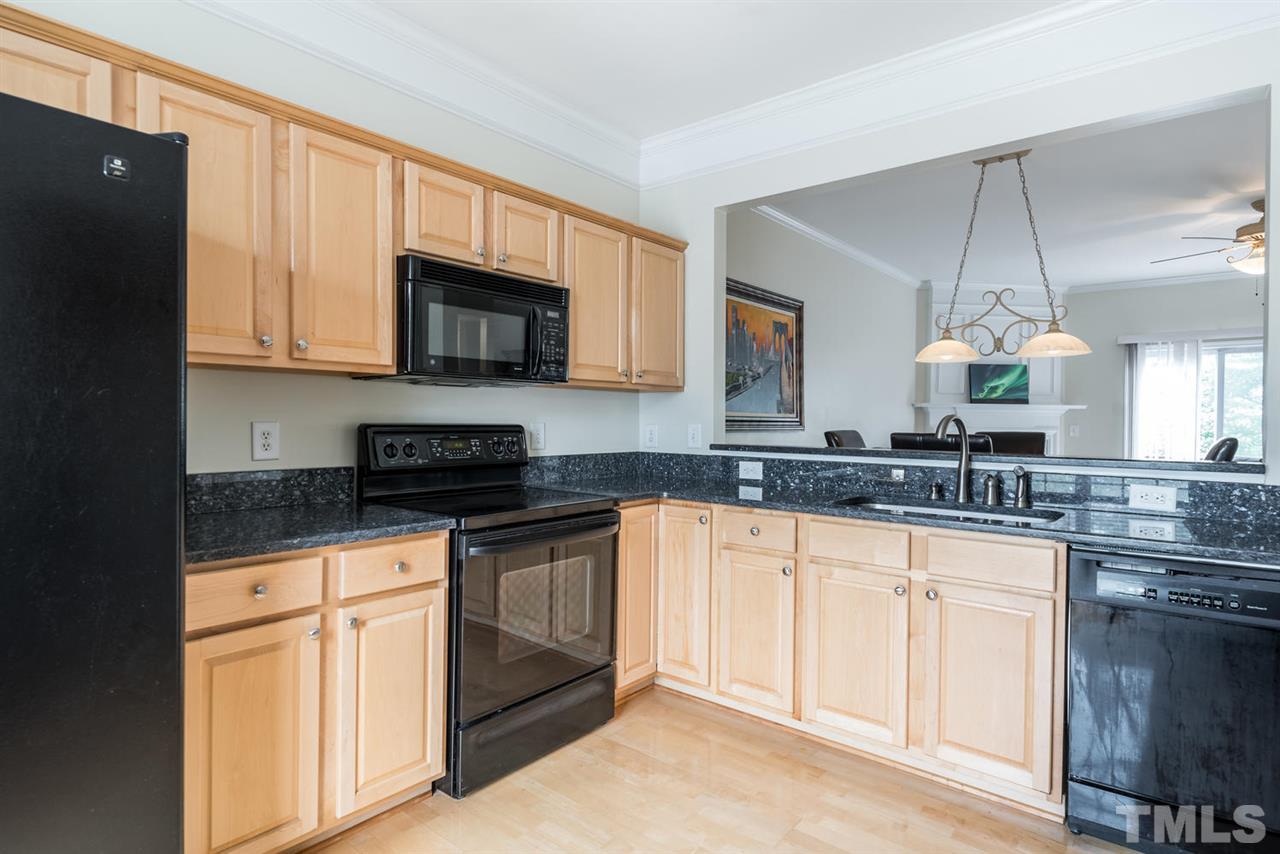 5522 Shady Crest Drive Raleigh, NC 27613 - Photo 10 of 25 a kitchen with granite countertop a stove sink and cabinets