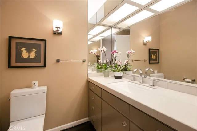 a bathroom with a sink mirror and vanity
