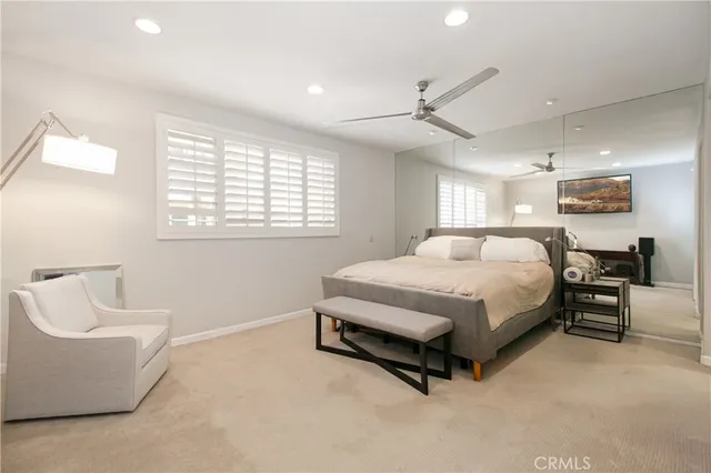 a spacious bedroom with a bed and a couch