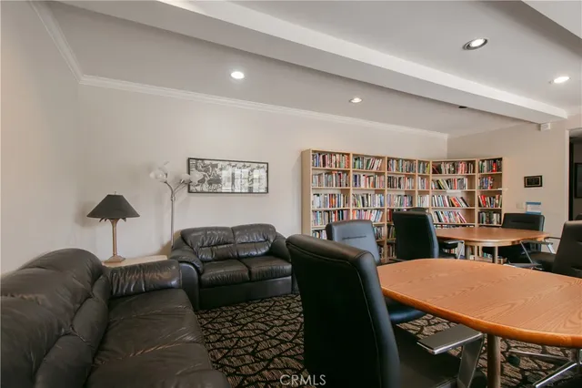 a living room with furniture a lamp and a bookshelf