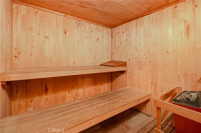 a view of room with furniture and wooden walls