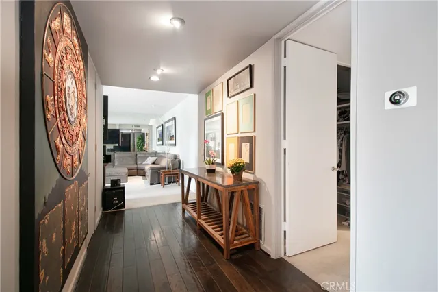 a view of a hallway with dining table and chairs