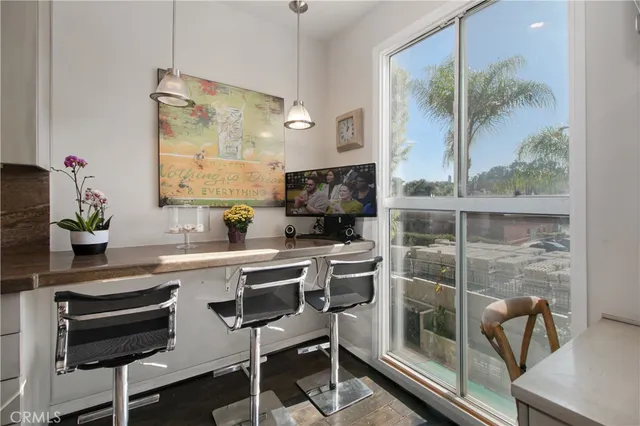 a kitchen with a sink and chairs