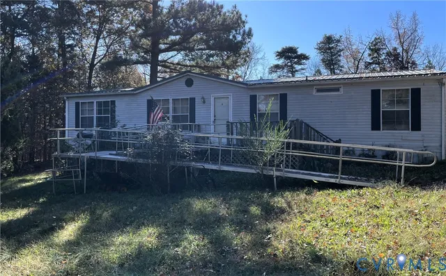 a backyard of a house with a yard and wooden fence