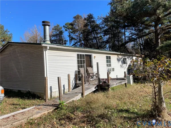 a backyard of a house with barbeque oven and outdoor seating