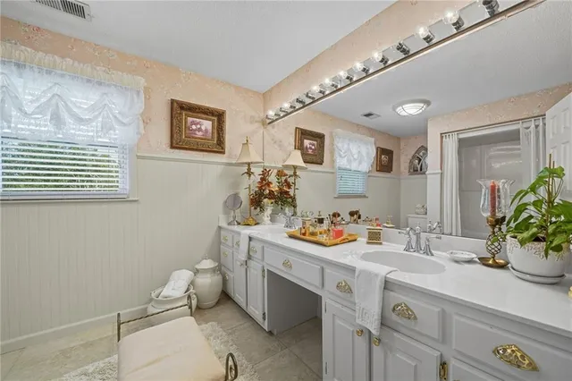 a bathroom with a toilet a sink and a mirror