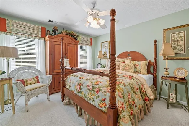 an aerial view of a house with a yard and tennis court